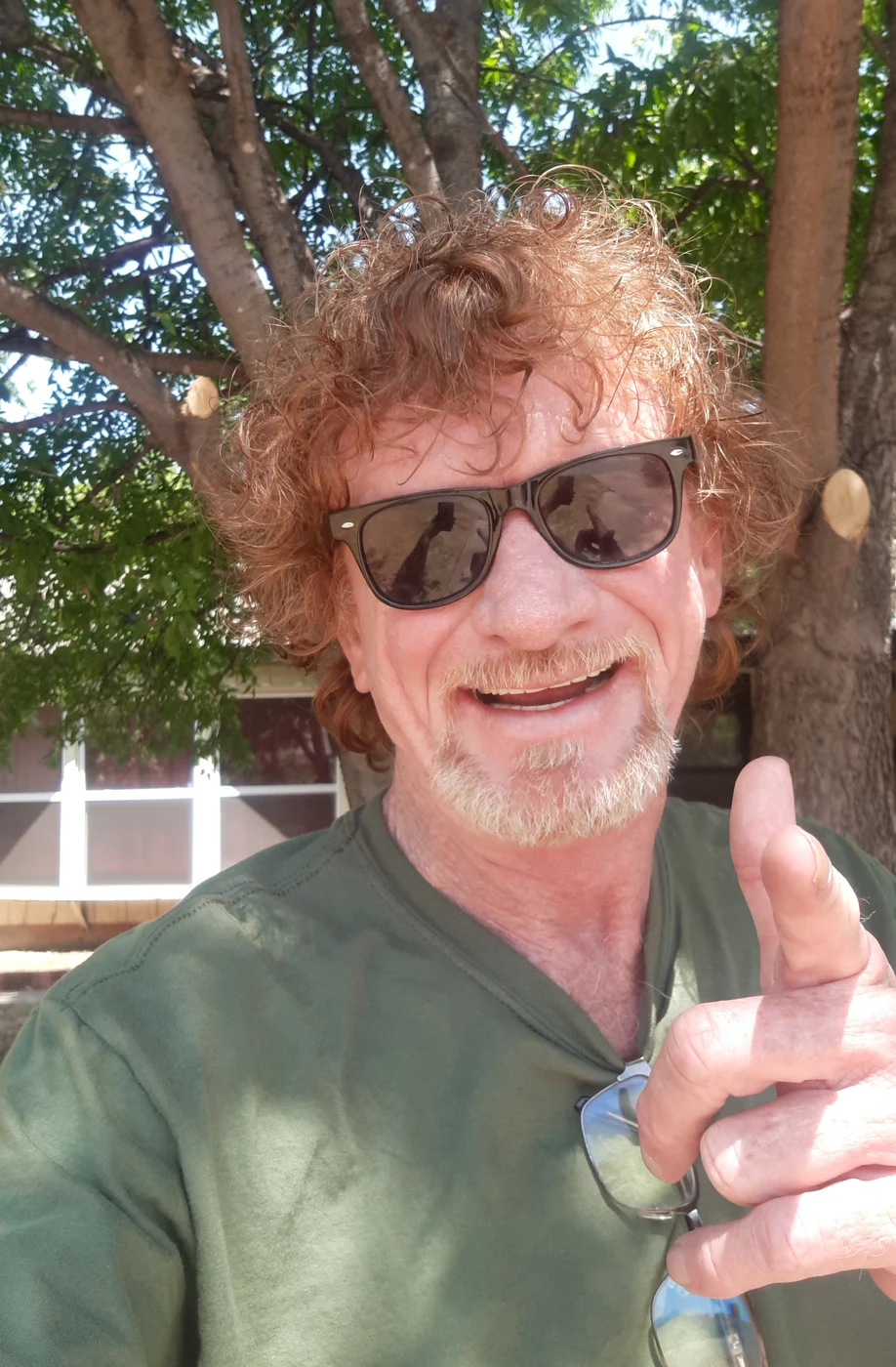 Bill Baker smiling outside a house